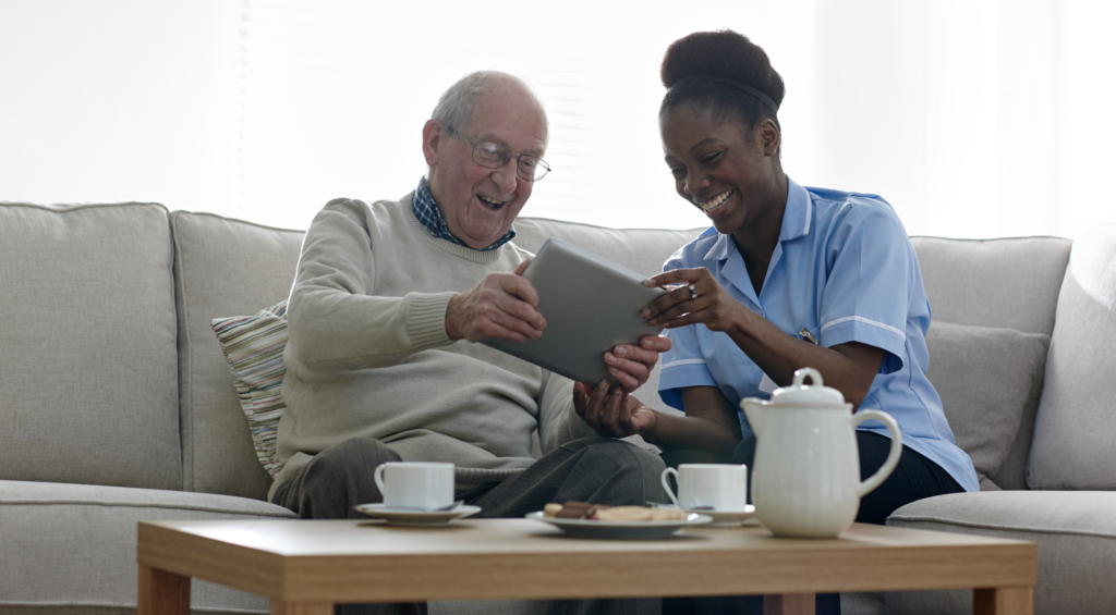 A therapist supporting an older adult with home-based care.